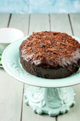 Traditional Austrian Sacher chocolate cake with crumbles served as close-up on an ceramic cake plate