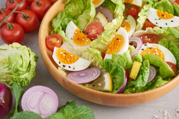 Diet menu. Healthy salad of fresh vegetables - tomatoes, egg, Onion. high angle view of a nutritious vegetable salad with boiled egg slices, served.  Healthy meal concept.