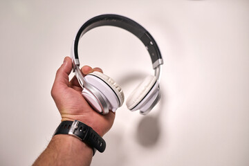 A man holding a pair of headphones