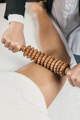 Stimulation of the lymphatic system with wood therapy body treatment. Massage with wooden roller to...