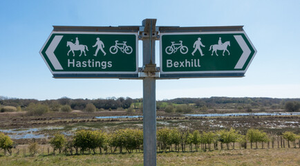 A signpost indicates direction to Bexhill and Hastings.Indicates suitable for bicycles, people and horses.Coombe Valley.Sussex.UK © Tony Skerl