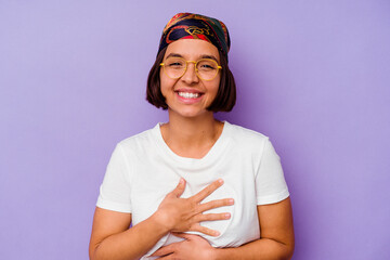 Young mixed race woman wearing a bandana isolated on purple background laughing and having fun.