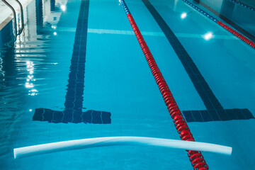 a water pool with blue transparent clear water, on which bright sunlight shines. Water lanes in the...