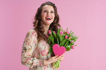 happy woman with long wavy brunette hair on pink