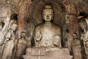 Fototapeta na wymiar Carved Buddha Limestone at Longmen Grottoes or Caves (Dragon gate Grottoes), The World Heritage Site in Luoyang, Henan province, China.