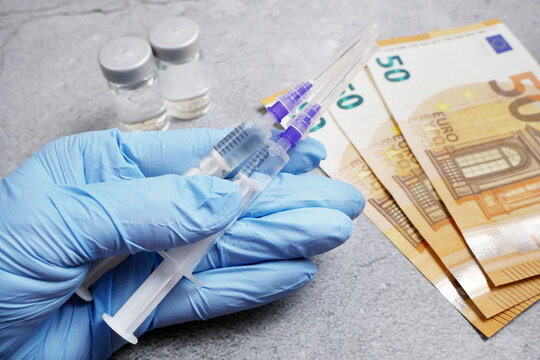 bottle of vaccine and money, money for purchase and production vaccine concept