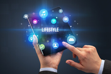 Businessman holding a foldable smartphone