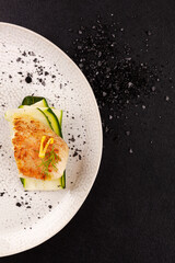 Luxurious seafood dinner. Perch fish fillet on zucchini slices.