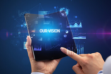 Businessman holding a foldable smartphone, business concept