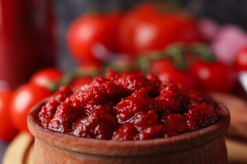 Wooden bowl with tomato paste, close up