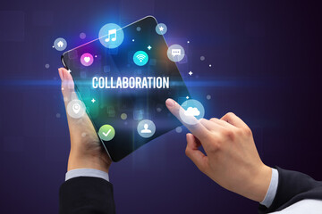 Businessman holding a foldable smartphone