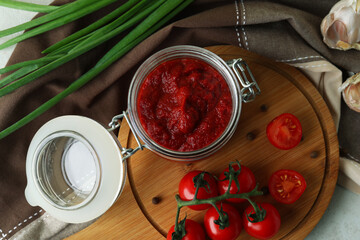 Jar with tomato paste and ingredients, top view