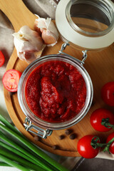 Jar with tomato paste and ingredients, top view