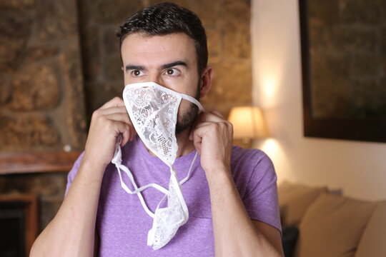 Man smelling lingerie with passion