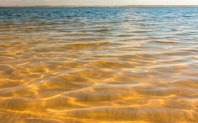 water texture with waves. sea waves with sun glare.