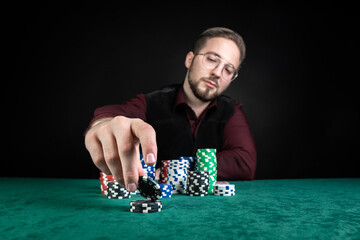 A young poker player has a lot of chips on the table.