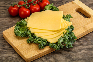 Sliced Gauda cheese over board