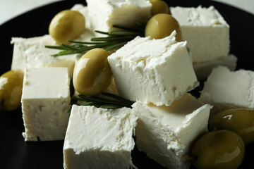 Feta cheese pieces, olives and rosemary, close up