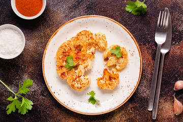 Cauliflower steak with spices cooked in the oven, top view.