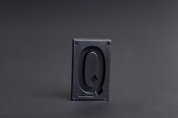 Letter Press Q on black background