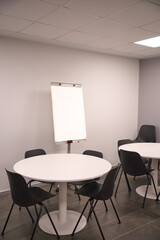 A room filled with furniture and a table with a white board to white in
