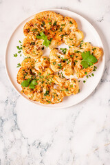 Cauliflower steak with spices cooked in the oven, top view.