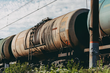 railway tank car bottom view .Tanks with fuel being transported by rail vintage. passing freight train. tinted finish.