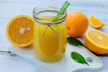 Fototapeta na wymiar Fresh orange juice nv light background. Close-up.