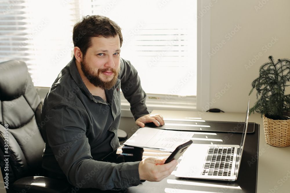 Wall mural office worker using smatrphone and laptop working.