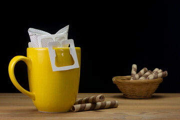 preparing a cup of filter coffee on wooden table. Black background