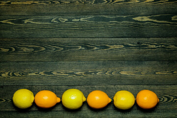 

Ripe source lemons  on a wooden background  photographed from above in the form of a frame

