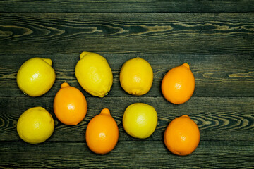 

Ripe source lemons  on a wooden background  photographed from above in the form of a frame

