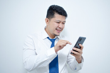 Young Asian businessman with mobile phone on light background