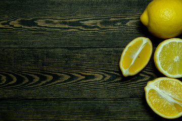 

Ripe source lemons  on a wooden background  photographed from above in the form of a frame

