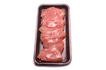 Turkey fillet in a black plastic container isolated.