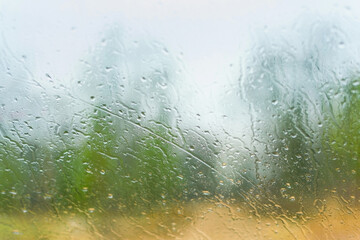raindrops on the wet transparent glass. Blurred background