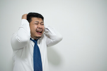 Asian man wearing a blue tie is stressed.