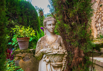 Beautiful stone sculpture in the shape of a woman, used as a decoration in a park.