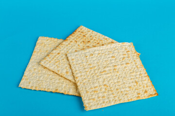 Matzo plates laid out in any shape on a blue background.