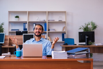 Young male employee working in the office