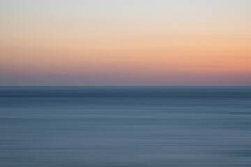 Obraz premium Beautiful long exposure landscape image of calm sea and colorful sunset sky