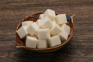 Refined white sugar cubs in the bowl