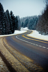 Winter road through the forest