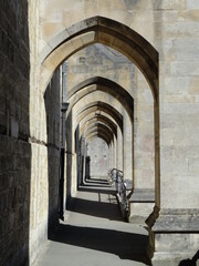 Corridor under the arches of a church. Old stone walls and architecture.