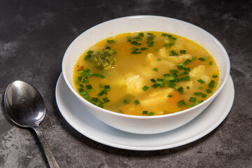 Vegetable soup. Serve the soup with bread. Ready-made vegetable lunch for lunch, hot soup for dinner at home. Soup with potatoes, carrots, broccoli, cauliflower and chicken fillet.