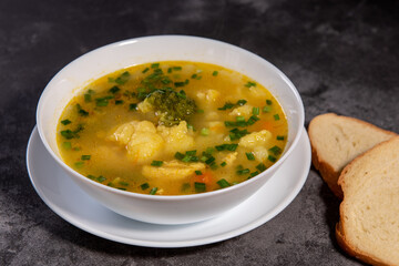 Vegetable soup. Serve the soup with bread. Ready-made vegetable lunch for lunch, hot soup for dinner at home. Soup with potatoes, carrots, broccoli, cauliflower and chicken fillet.