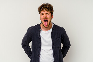 Young caucasian man isolated on white background funny and friendly sticking out tongue.