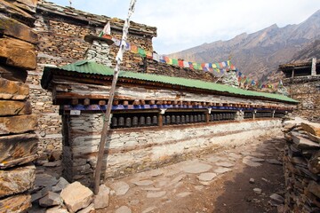 Buddhist prayer many wall with prayer wheels