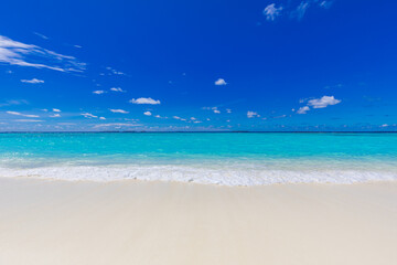 Closeup of sand on beach and blue summer sky. Panoramic beach landscape. Empty tropical beach and seascape. Vacation coast, shore blue sky, soft sand, calmness, tranquil relaxing sunlight, summer mood