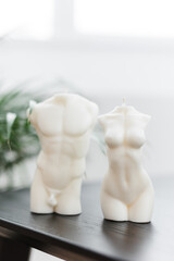 two candles in the form of a male and female figure in white. home decor concept.